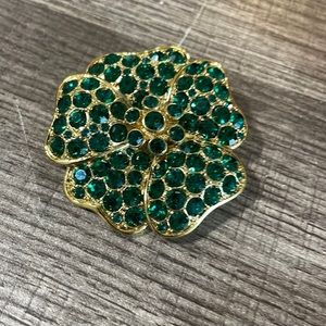 Gold with green rhinestones vintage Monet brooch.